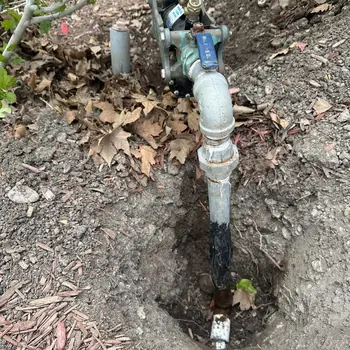 New backflow preventer and mainline valve installed in a service pit