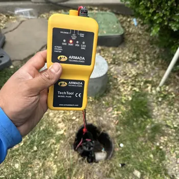 Technician testing a valve solenoid with a wire fault locator over an open valve box