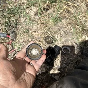 A dirt-clogged sprinkler valve diaphragm pulled out and cleaned